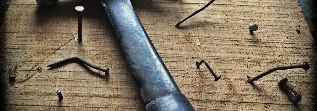 black claw hammer on brown wooden plank