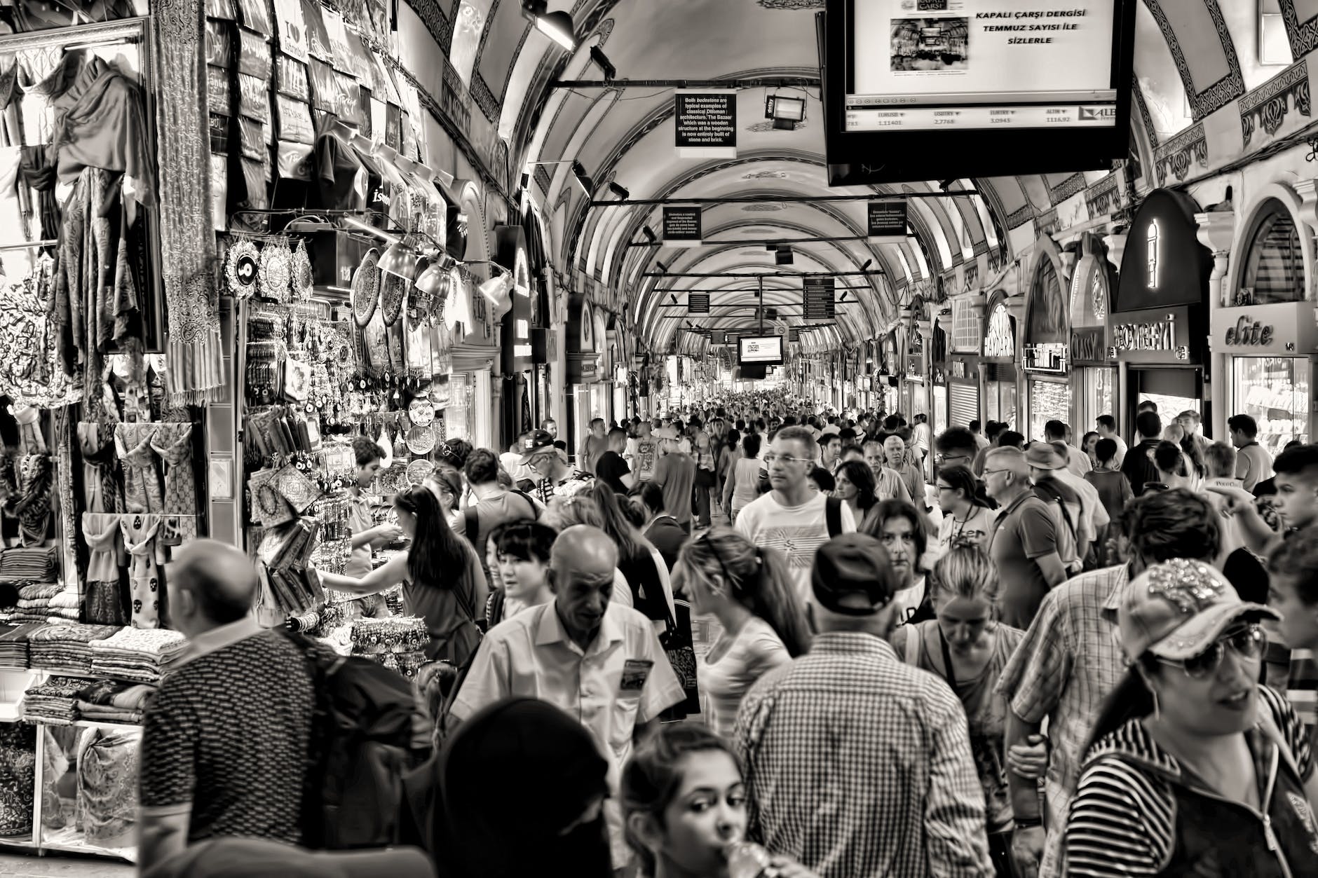 grayscale photo of people at market